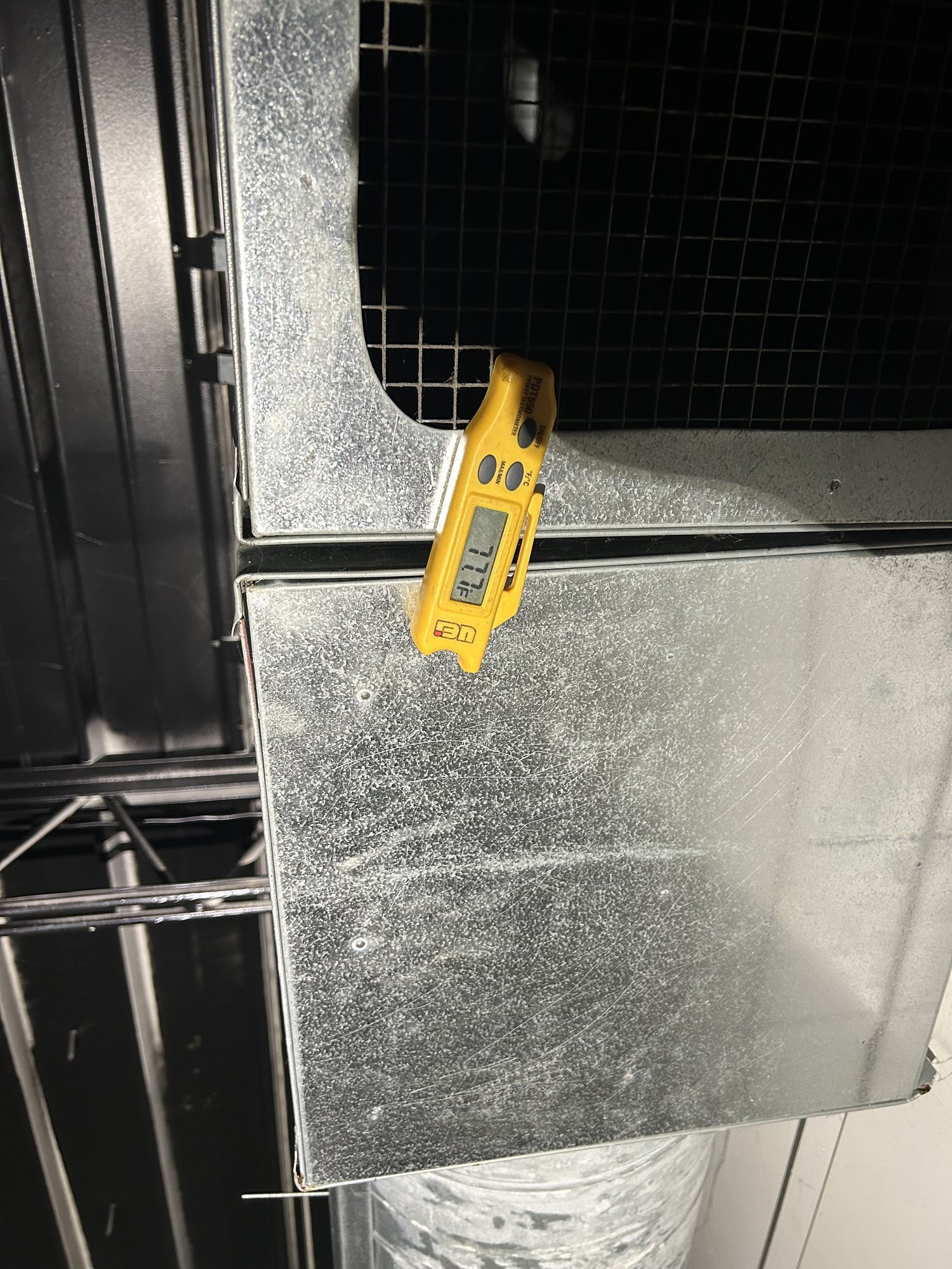 Frost showing up on the air-handler cabinet during diagnosis — a visible sign the coil inside has dropped below freezing.
