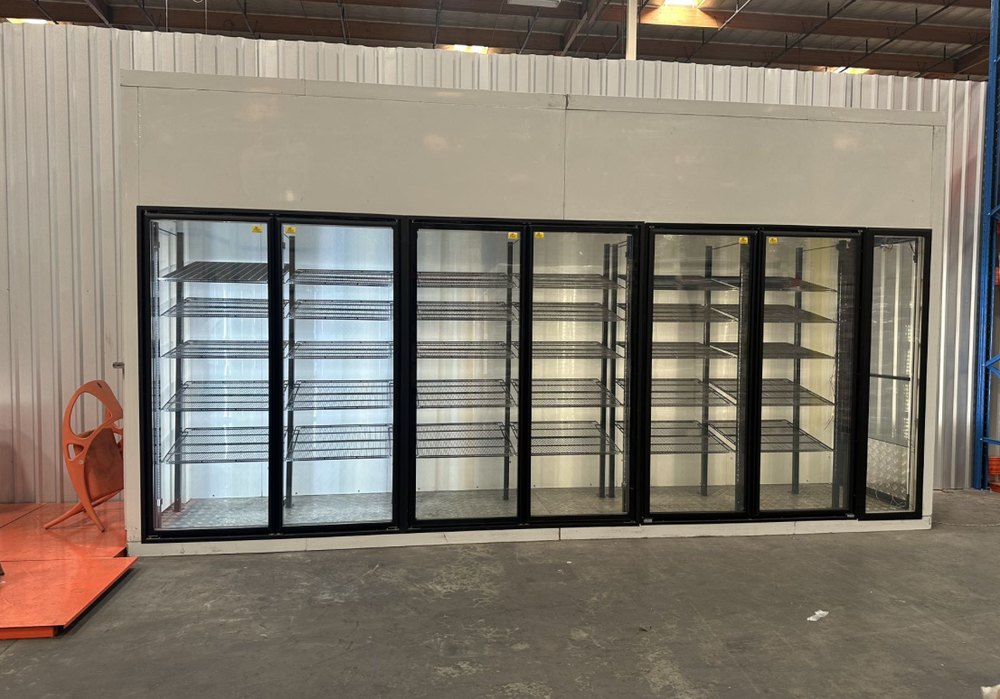 New walk-in beer cooler build with a row of glass merchandising doors