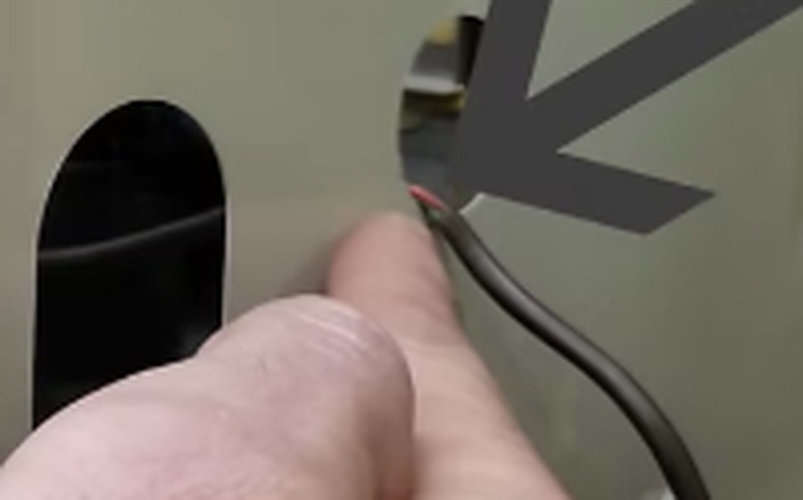 Thermostat wire dragged across a sharp sheet-metal edge at the cabinet — vibration eventually wears through the jacket and shorts the 24-volt circuit.