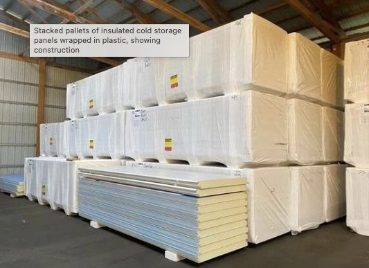 Insulated metal panels stacked and ready — they ship flat and assemble on site.
