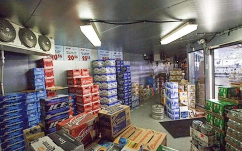 Inside a stocked liquor store beer walk-in cooler