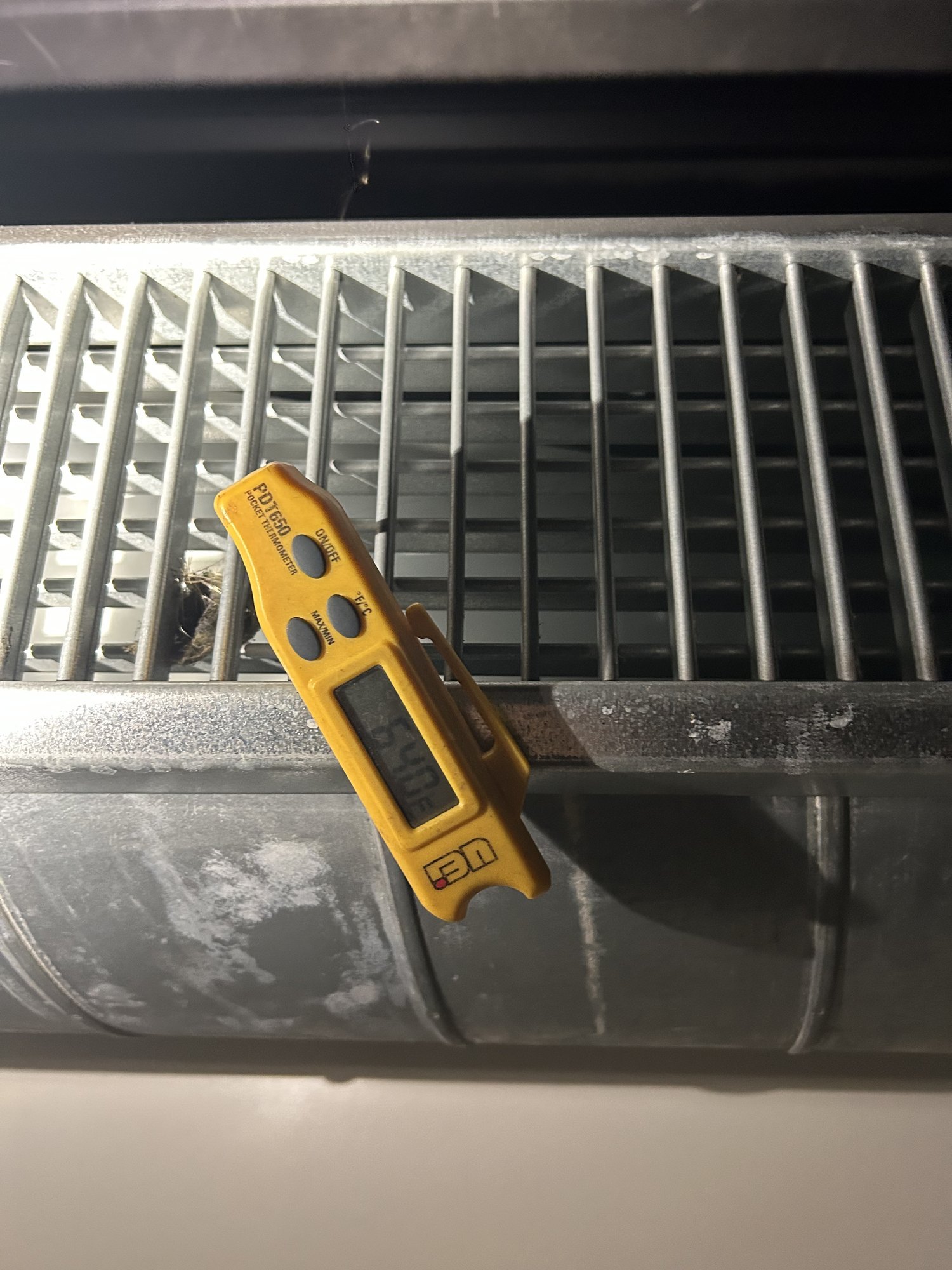 Checking air temperature at the register — a wide supply-to-return temperature split alongside low airflow points straight at an air-starved coil.