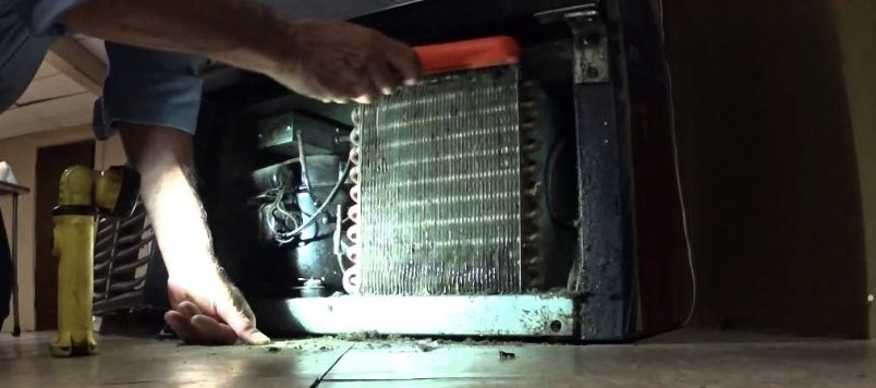 Technician servicing a self-contained condenser coil