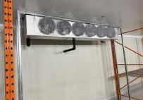 The evaporator (unit cooler) hangs inside the box, moving air across a cold coil.