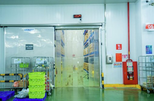 A horizontal sliding freezer door saves floor space and handles loaded carts and forklifts.